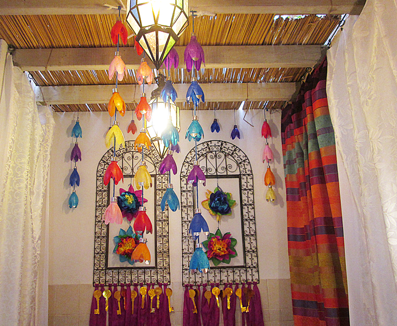 A Sukkah With Soda Bottle Flowers In Rainbow Colors!