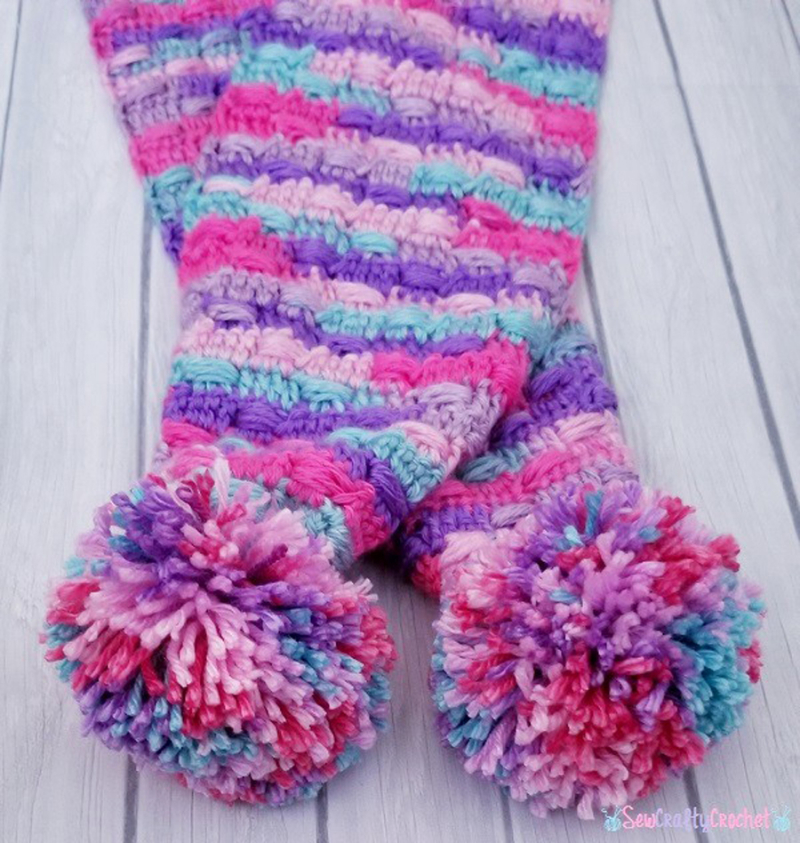 Crocheted-unicorn-colors-scarf-with-pom-poms